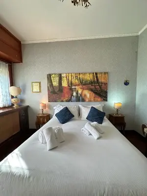 a bedroom with a large white bed with blue pillows at 6 people, 3 parking spot, balconies, Metro B in Rome