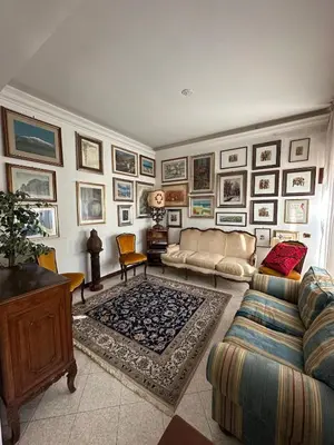a living room with a couch and pictures on the wall at 6 people, 3 parking spot, balconies, Metro B in Rome