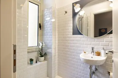 a bedroom with a bed and a bathroom with a tub at Savi Guest House metro B S Paolo in Rome