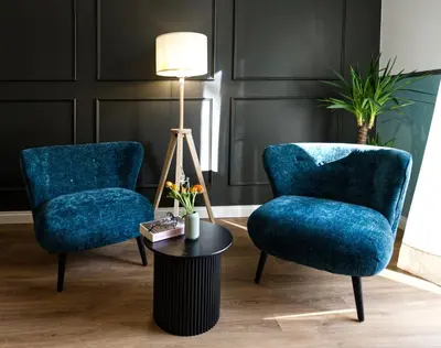 a living room with blue chairs and a table at Savi Guest House metro B S Paolo in Rome