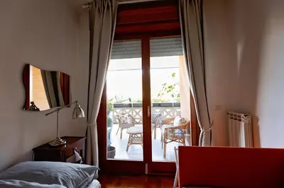 a bedroom with a bed and a sliding glass door at Holiday Home Roma in Rome