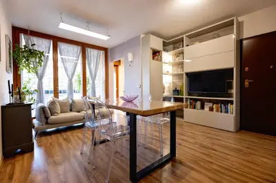 a living room with a table and a couch at Holiday Home Roma in Rome