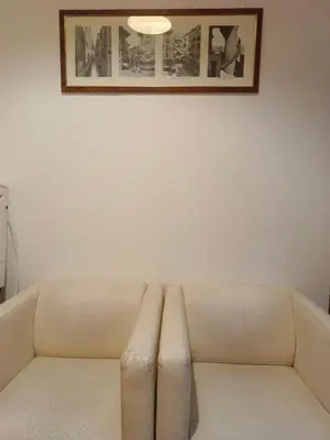 a couch in a room with a picture on the wall at Niam House in Rome