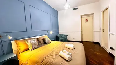 a bedroom with a large yellow bed with two pillows at Raffy in Rome in Rome