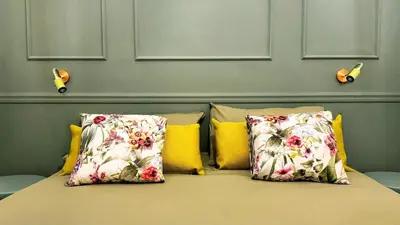 a bed with three pillows on it with a wall at Raffy in Rome in Rome