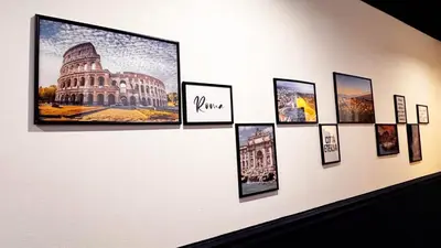 a wall with framed photographs on a wall at Raffy in Rome in Rome
