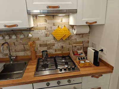 a kitchen with a stove and a sink at Angolo Romano in Rome