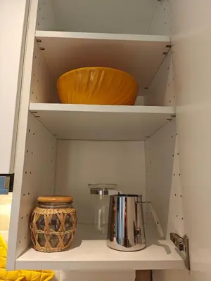 a white shelf with a pot and a bowl on it at Angolo Romano in Rome