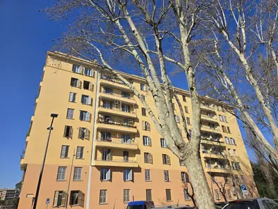 a tall building with a tree in front of it at Angolo Romano in Rome