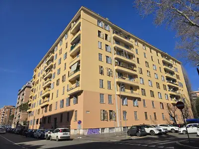 a tall building with cars parked in a parking lot at Angolo Romano in Rome