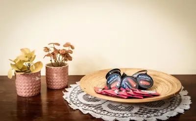 a wooden plate with pairs of shoes on a table at Laterani36 elegante Appartamento 3 Camere, sopra Metro Porta Metronia in Rome