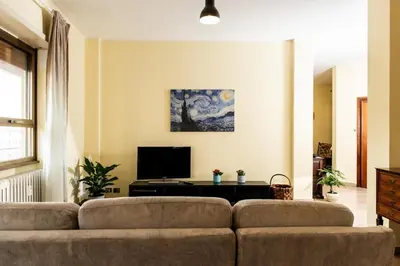 a living room with a couch and a tv at Laterani36 elegante Appartamento 3 Camere, sopra Metro Porta Metronia in Rome