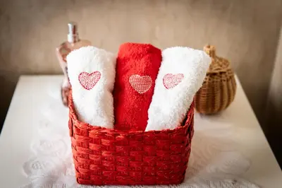 two towels in a basket on a table at Laterani36 elegante Appartamento 3 Camere, sopra Metro Porta Metronia in Rome