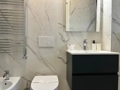 a bathroom with a sink and a toilet and a mirror at Holidays in Rome at Luigi's in Rome