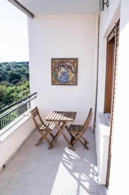 two chairs and a table on a balcony at Holidays in Rome at Luigi's in Rome