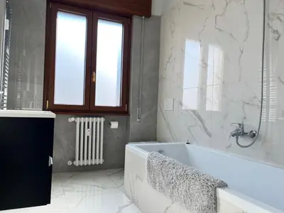 a white bathroom with a tub and a window at Holidays in Rome at Luigi's in Rome