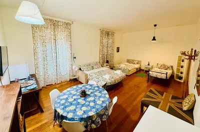 a living room with a table and a couch at TURATI ROOMs in Rome