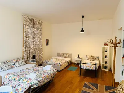 a living room with two beds and a couch at TURATI ROOMs in Rome