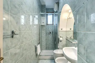 a bathroom with a sink toilet and a mirror at Fresh House Ludovisi in Rome