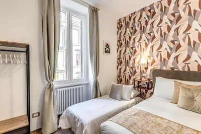 a bedroom with two beds and a window at Casa Bixio Fantastico appartamento nel cuore di Roma in Rome