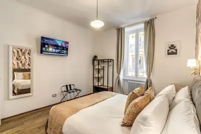 a bedroom with a bed and a tv on the wall at Casa Bixio Fantastico appartamento nel cuore di Roma in Rome