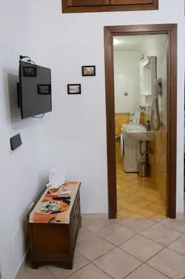 a bathroom with a counter and a sink and a mirror at Casa di Roberto - Metro e Servizi a due passi! in Rome