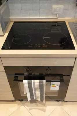 a stove top oven sitting in a kitchen at Casa di Roberto - Metro e Servizi a due passi! in Rome