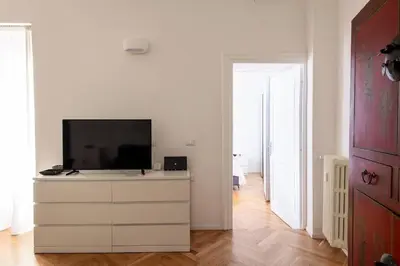 a living room with a television on a dresser at ST PETER APARTMENT metro at 3 minutes in Rome