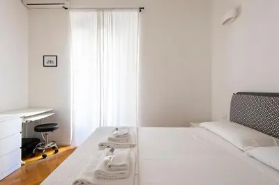 a white bedroom with a bed with towels on it at ST PETER APARTMENT metro at 3 minutes in Rome