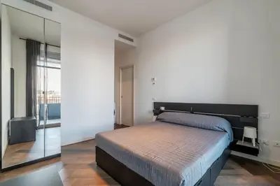 a bedroom with a bed and a large mirror at GuestHost - Ostiense Modern ApartamentS in Rome