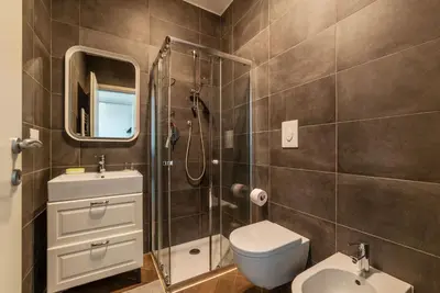 a bathroom with a shower and a toilet and a sink at GuestHost - Ostiense Modern ApartamentS in Rome