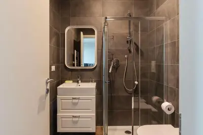 a bathroom with a sink and a shower with a mirror at GuestHost - Ostiense Modern ApartamentS in Rome