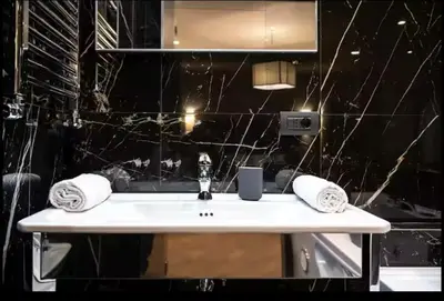 a bathroom with a sink and a black wall at Elegante loft nel cuore di Roma in Rome