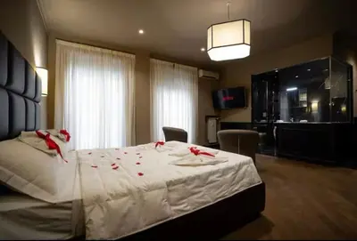 a bedroom with a bed with red rose petals on it at Elegante loft nel cuore di Roma in Rome