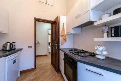 a kitchen with a stove and a counter top at Margana Luxury 3 bedrooms amazing terrace in Rome