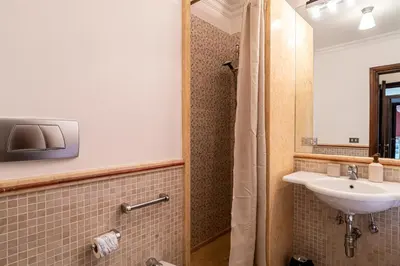 a bathroom with a sink and a mirror at Margana Luxury 3 bedrooms amazing terrace in Rome