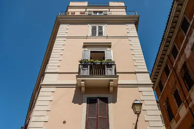 a tall building with a balcony with flowers on it at Margana Luxury 3 bedrooms amazing terrace in Rome