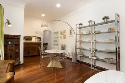a dining room with a table and shelves at Cozy Gambero Apartments in Rome