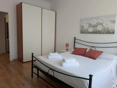 a bedroom with a white bed with red pillows on it at Da Tony vicino San Pietro in Rome