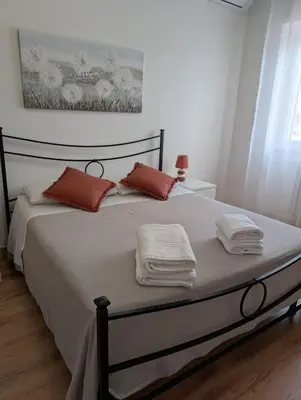 a bedroom with a bed with towels on it at Da Tony vicino San Pietro in Rome