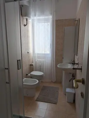 a bathroom with a toilet and a sink at Da Tony vicino San Pietro in Rome