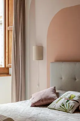a bedroom with a bed and a lamp and a window at Suite METRO Cavour 200m Coliseum in Rome