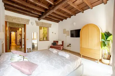 a bedroom with a large bed with pink pillows at Suite METRO Cavour 200m Coliseum in Rome