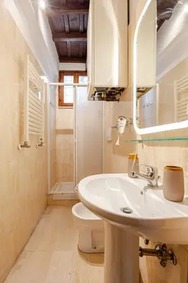 a bathroom with a sink and a toilet and a mirror at Suite METRO Cavour 200m Coliseum in Rome