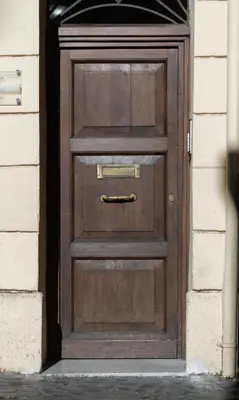 a wooden door with a handle on a building at Suite METRO Cavour 200m Coliseum in Rome