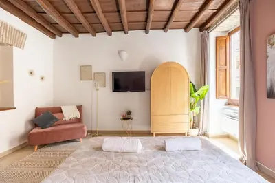 a bedroom with a large bed and a couch at Suite METRO Cavour 200m Coliseum in Rome