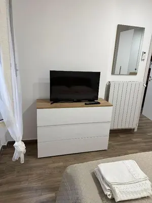 a tv on top of a dresser in a room at Imperial Apartment in Rome