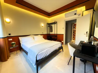 a bedroom with a bed and a desk and a computer at Vatican Domus Stefania Guest House in Rome