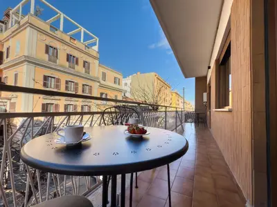 a table on a balcony with a cup of coffee at Vatican Domus Stefania Guest House in Rome