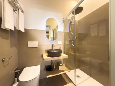 a bathroom with a sink and a toilet and a mirror at Vatican Domus Stefania Guest House in Rome